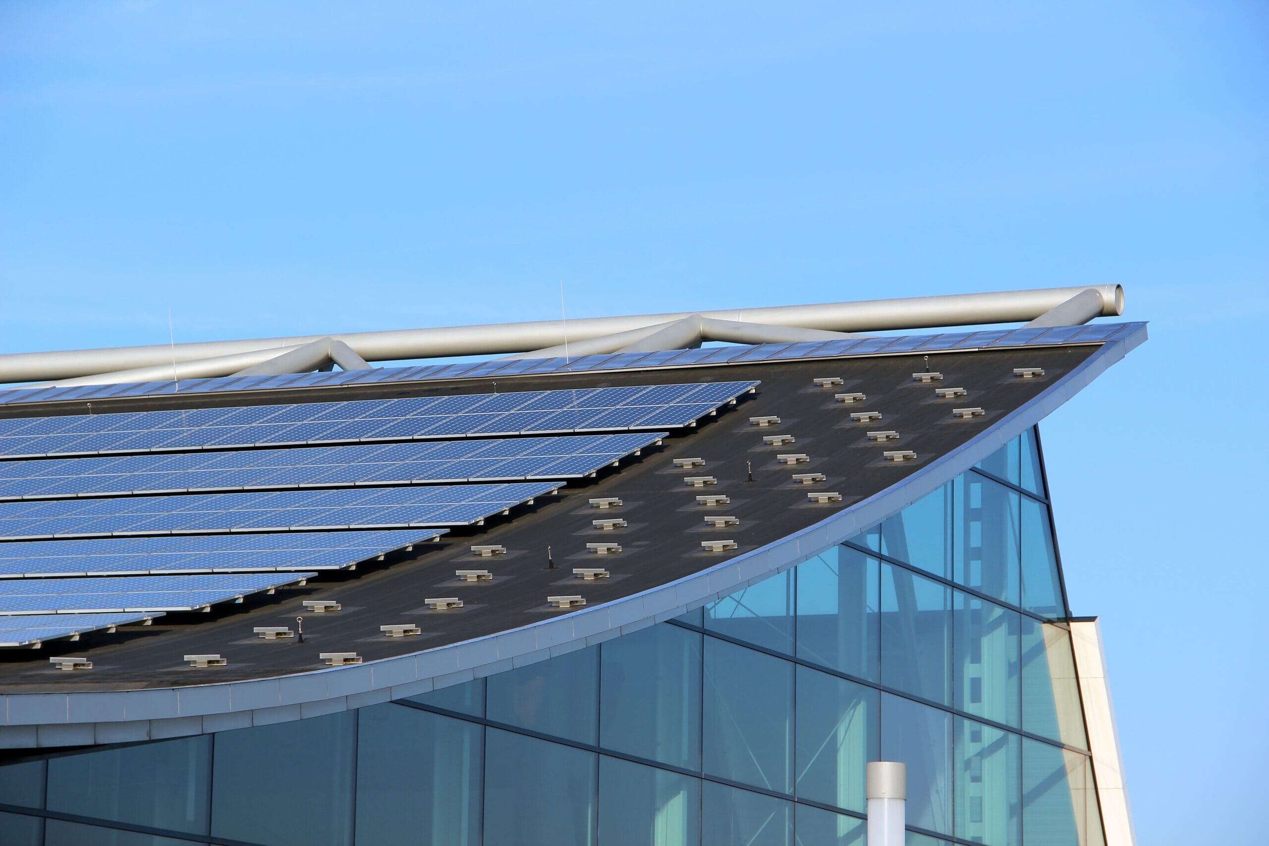 Close up of solar panels on a glass fronted commercial building