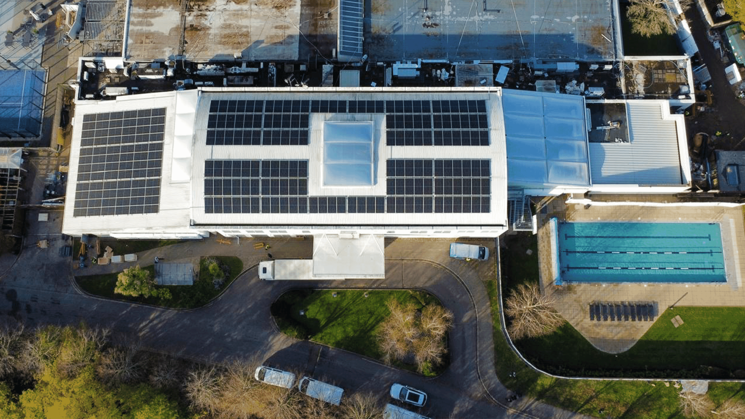 A commercial rooftop with solar panels on it